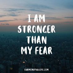 the words i am stronger than my fear are in front of a cityscape