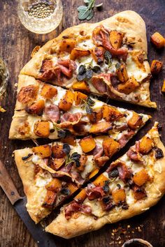 a pizza with lots of toppings sitting on top of a wooden cutting board