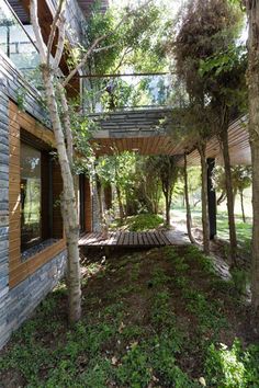 the house is surrounded by trees and grass