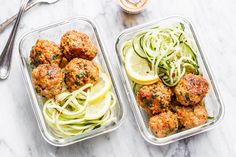 two plastic containers filled with meatballs and zucchini noodles next to a fork