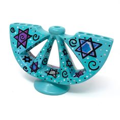 a blue ceramic figurine with stars and shapes on it