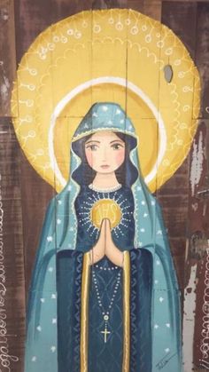 an image of the virgin mary in blue and gold on a wooden paneled wall