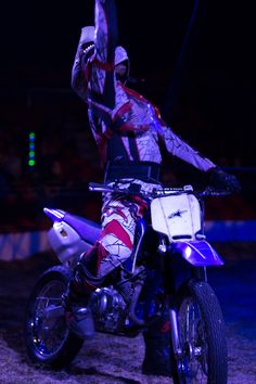 a man riding on the back of a dirt bike