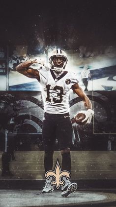 an image of a football player holding a ball in front of a wall with the new orleans saints on it