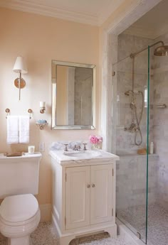 a bathroom with a toilet, sink and shower