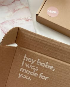 an open box with the words hey babe was made for you written on it, next to a pink and white marble countertop