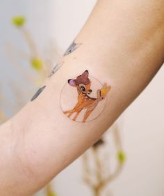 a small tattoo on the arm of a woman's arm with an image of a deer