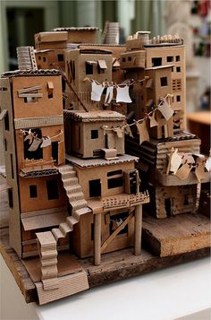 cardboard houses are stacked on top of each other