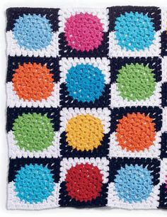 a crocheted square with different colored squares on it