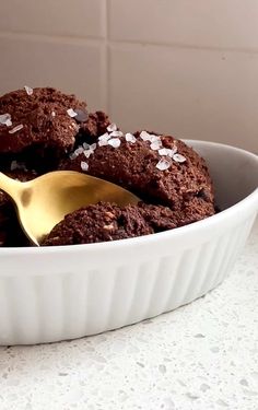 a close up of a bowl of food with a spoon