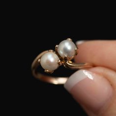 This stunning vintage cultured pearl bypass ring is a true treasure from the past. Crafted in solid 10k yellow gold, this toi et moi ring features 2 round cultured pearls, each held in place by 4 delicate prongs. The term "Toi et Moi" means "you and me," symbolizing the coming together of two individuals. With its timeless design and elegant beauty, this ring would make the perfect gift for a July birthday or a special anniversary. The ring is a size 5.75 and weighs 2.8 grams, making it a comfor Two Pearl Ring, Vintage Style Bypass Ring As Gift, Pearl Wedding Ring, Dream Rings, Cultured Pearl Ring, Elegant Beauty, Pearl And Diamond Ring, July Birthday, Bypass Ring