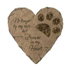 a stone heart shaped like a paw print with the words, no longer by my side but forever in my heart