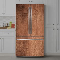 a wooden refrigerator freezer sitting in a kitchen next to white cupboards and cabinets