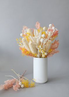 an arrangement of flowers in a white vase