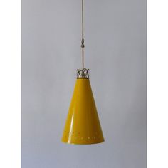 a yellow pendant light hanging from a ceiling