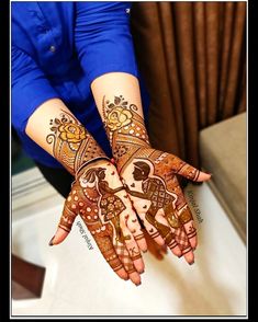 two hands with henna designs on them