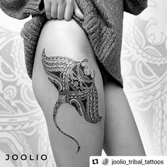 a woman's thigh with a tattoo design on it