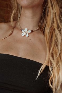 Elevate your beach style with our Surf Flower Macrame Shell Necklace, exclusively at Gardenbelle Shop. This gorgeous surfer-inspired necklace is crafted with real shells, a wooden bead, and intricately hand-tied cotton jute macrame. Designed to rest at a super flattering length of 15", it effortlessly adds a touch of bohemian charm to any outfit. Perfect for free spirits and beach lovers alike, this unique piece embodies our commitment to offering handmade, quality items. Embrace the ocean vibes and enhance your jewelry collection with this exquisite necklace. Cheap Adjustable Flower Necklace For Beach, Sea Shell Choker Necklace, Cheap Bohemian Shell Necklaces, Beach Shell Jewelry, Luxury Bohemian Shell Necklace For Beach, Beaded Shell Jewelry, Beachy Boho Jewelry, Boho Handmade Jewelry, Beach Beaded Jewelry