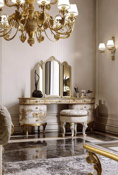 an ornately decorated dressing table and stools in a room with chandelier