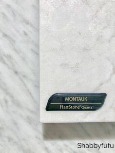 a white marble counter top with the name montauk in black lettering on it