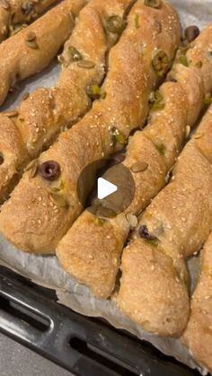 bread sticks with olives and pistachio on top