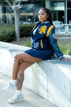 a woman sitting on top of a cement wall