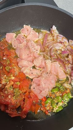 meat and vegetables cooking in a wok on the stove top with seasoning sprinkles