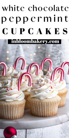 white chocolate peppermint cupcakes on a plate with candy canes in the foreground