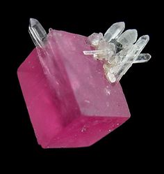 a pink object with some white crystals on it's end and one piece of glass in the middle