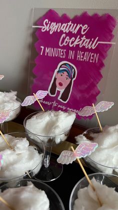 there are several desserts on the table with pink and white decorations in glasses next to a sign that says signature cocktail 1 minutes in heaven