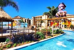 an outdoor swimming pool next to a resort