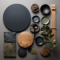 an assortment of plates and bowls on a table with plants in the middle, next to each other