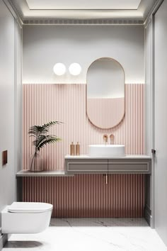 a bathroom with pink walls and white fixtures