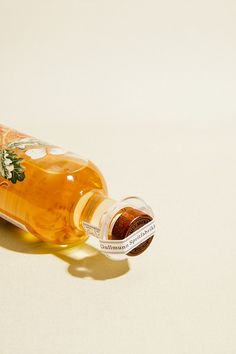 a bottle of starbucks coffee syrup on a white surface with the lid open and its cap off