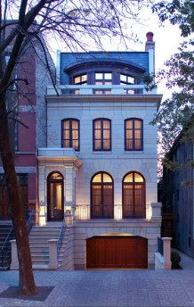 a two story house is lit up at night