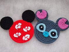 two crocheted mickey and minnie mouse coasters on a white surface, one with black ears