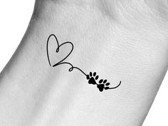 a dog paw with a heart tattoo on it