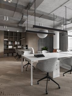 an office with white desks and chairs in it