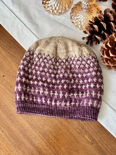 "Light hand-knit beanie! Made from 100% wool. The beanie will stretch but best fit heads 21\"-23\" in circumference. Washing Instructions: hand-wash, laid flat to dry. Please note: coloring can vary and may not exactly match the photograph." Purple Beanie Hat, One Size, Purple Winter Hat For Cold Weather, Purple Beanie For Fall, Purple One Size Beanie Hat, Hand Knitted Purple Hat One Size, Hand Knitted One Size Purple Hats, Hand Knitted Purple Hat, Hand-knitted One Size Purple Hat, Purple Hat For Fall