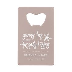 a pink bottle opener with the words sandy toes and salty kisses on it's front