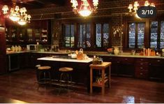 a kitchen with wooden floors and lots of lights