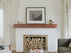 a living room filled with furniture and a fire place in front of a painting on the wall