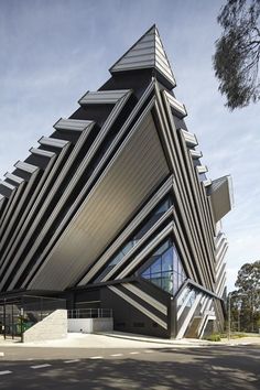 an unusual building with black and white stripes on it