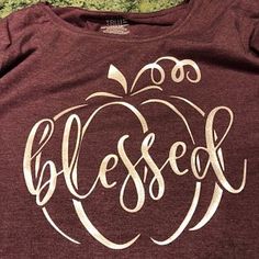 a maroon shirt with the word blessed written on it