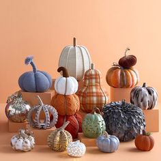 a group of pumpkins sitting on top of a wooden box next to each other