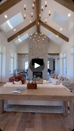 a living room filled with furniture and a fire place in the middle of an open floor plan