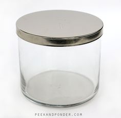 a glass jar with a metal lid on a white surface, showing the bottom portion