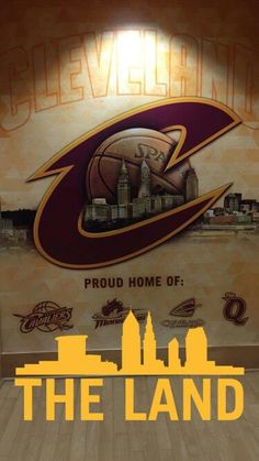 the cleveland basketball team logo is displayed in front of a wall mural that reads proud home of the land