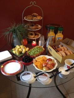 a glass table topped with plates and bowls filled with different types of food on top of it