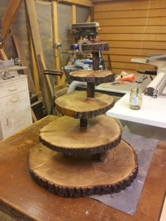 three wood slices stacked on top of each other in a room with tools and equipment